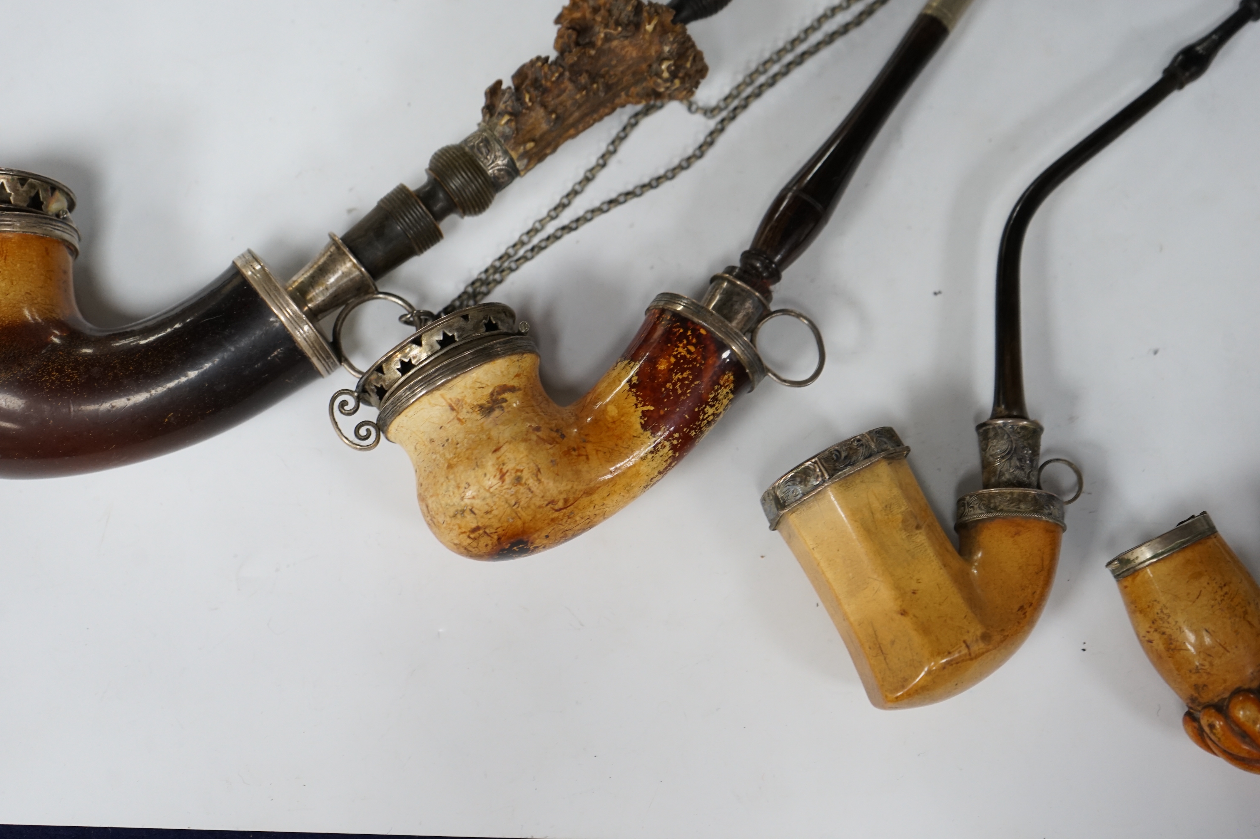 Four early Meerschaum pipes of varying sizes, largest 41cm high